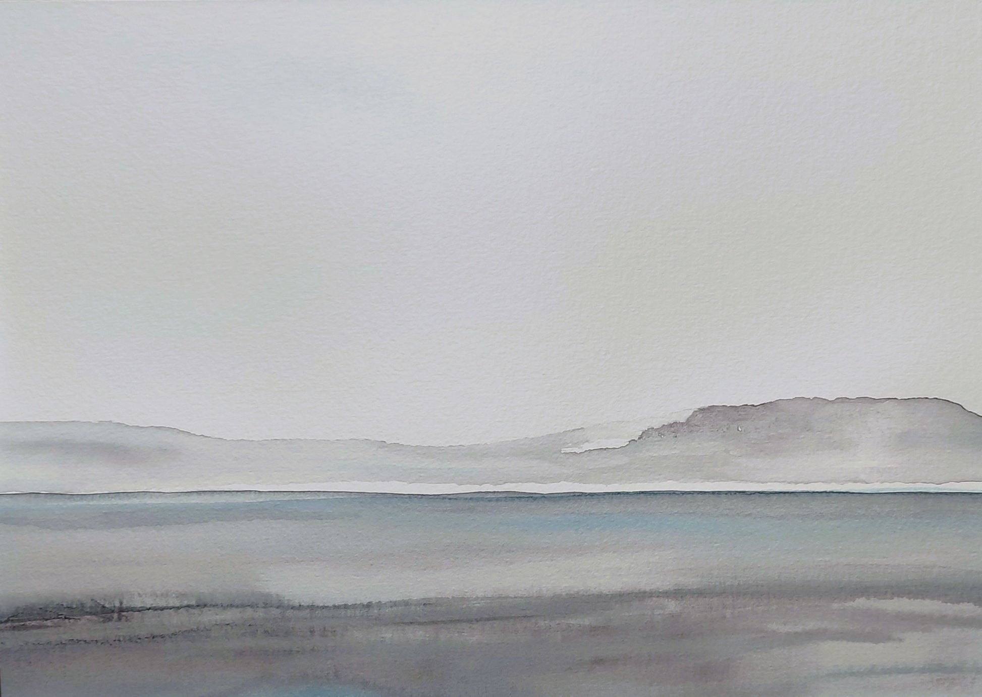 Image of a calm lake with simple foreground detail and distant fell, in a palette of greys with a soft blue