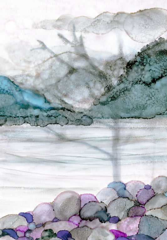 Close-up of a colourful pebble surface with a shadow of a tree overlooking a lake with distant mountains, a mix of white, grey, and blue  and purple colours 
